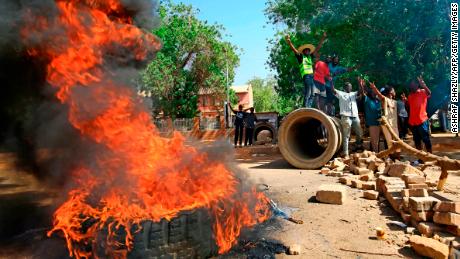 Sudanese protesters burn tires as they block Nile Street, a major thoroughfare, on Monday.