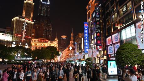 People walking through a shopping area in Shanghai. China&#39;s retail sales growth cooled significantly last month, according to figures released Wednesday.