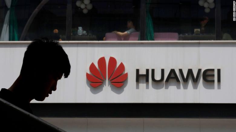 A Chinese man is silhouetted near the Huawei logo in Beijing on Thursday, May 16, 2019. In a fateful swipe at telecommunications giant Huawei, the Trump administration issued an executive order Wednesday apparently aimed at banning its equipment from U.S. networks and said it was subjecting the Chinese company to strict export controls. (AP Photo/Ng Han Guan)