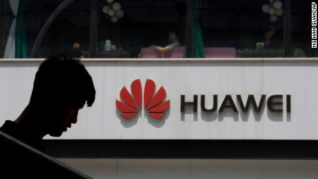 A Chinese man is silhouetted near the Huawei logo in Beijing on Thursday, May 16, 2019. In a fateful swipe at telecommunications giant Huawei, the Trump administration issued an executive order Wednesday apparently aimed at banning its equipment from U.S. networks and said it was subjecting the Chinese company to strict export controls. (AP Photo/Ng Han Guan)