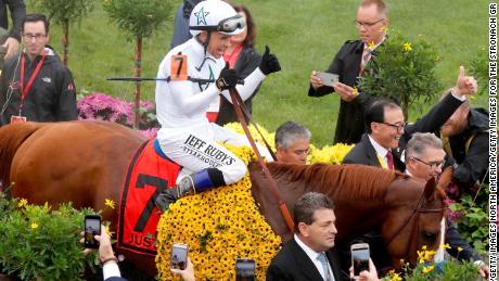 Jockey Mike Smith and racing horse Justify enter the winners circle at the 143rd Preakness Stakes. 