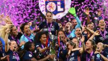 TOPSHOT - Olympique Lyonnais&#39; French defender Wendie Renard (C) holds the trophy with teammates as they celebrate their victory after the UEFA Women&#39;s Champions League final football match Vfl Wolfsburg vs Olympique Lyonnais at the Valeriy Lobanovsky stadium in Kiev on May 24, 2018. - Olympique Lyonnais won 4-1, their third trophy in a row. (Photo by FRANCK FIFE / AFP)        (Photo credit should read FRANCK FIFE/AFP/Getty Images)