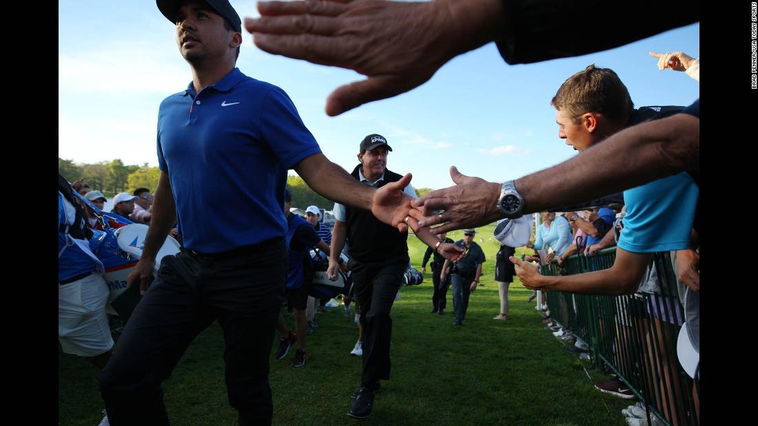 Phil Mickelson and Jason Day salute their fans as they complete solid first rounds of 1 under par.