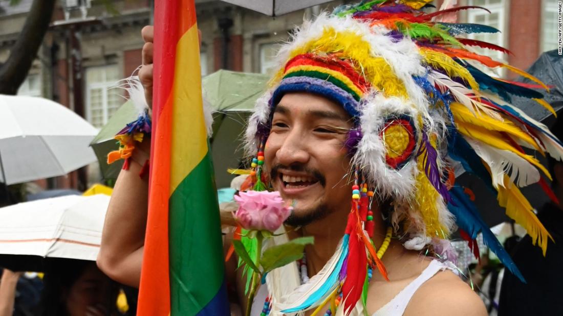 A gay rights advocate holds a flower in  support of the same-sex marriage law.