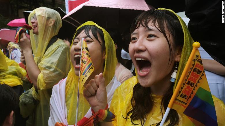 Same-sex marriage supporters shout during a parliament vote on three draft bills of a same-sex marriage law, outside the Legislative Yuan in Taipei, on Friday.