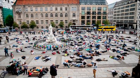 Extinction Rebellion climate change activists lie on the floor to symbolize a &quot;mass die&quot; at the Gendarmenmarkt square in Berlin on April 27, 2019.