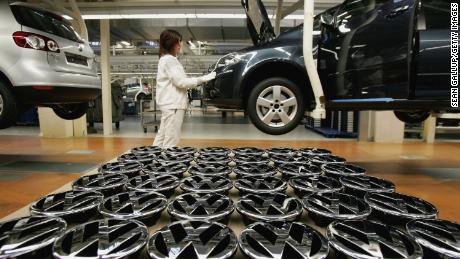 A worker stands by Volkswagen hood ornaments at the Golf production line at the Volkswagen factory in Wolfsburg, Germany.