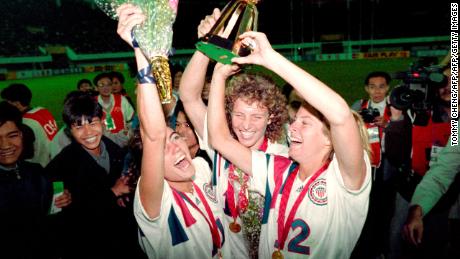 Michelle Akers-Stahl (C), Julie Foudy (L) and Carin Jennings (R) celebrate winning the first Women&#39;s World Cup held in 1991.
