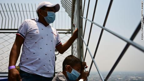 Visitors enjoy the view --despite air pollution -- from the Latin American tower viewpoint in Mexico City on May 14, 2019.
