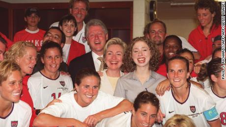 US President Bill Clinton (L), First Lady Hillary Clinton (C) and daughter Chelsea Clinton with members of the U.S. Women&#39;s soccer team in the locker room.