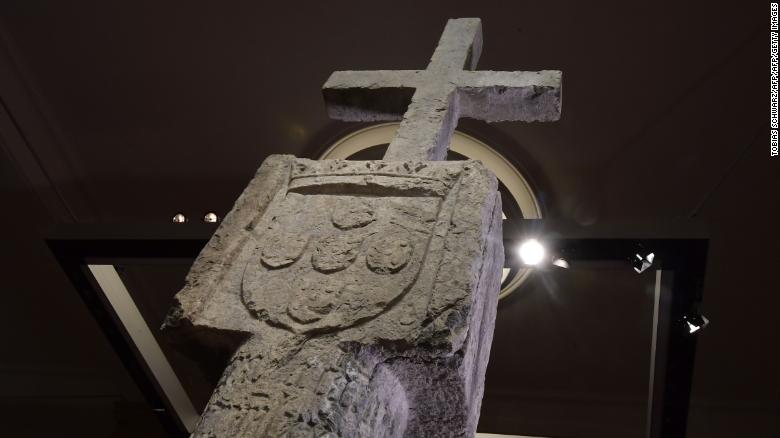 A picture taken on May 17, 2019 in Berlin shows a Stone Cross, a key 15th-century navigation landmark erected by Portuguese explorers, seen at the History Museum in Berlin. - The History Museum museum announced it would restitute the cross to Namibia as part of Berlin&#39;s efforts to face up to its colonial past. Placed in 1486 on the western coast of what is today Namibia, the Stone Cross was once considered to be such an important navigation marker that it featured on old world maps. In the 1890s, it was removed from its spot on Cape Cross and brought to Europe by the region&#39;s then German colonial masters. (Photo by Tobias SCHWARZ / AFP)        (Photo credit should read TOBIAS SCHWARZ/AFP/Getty Images)