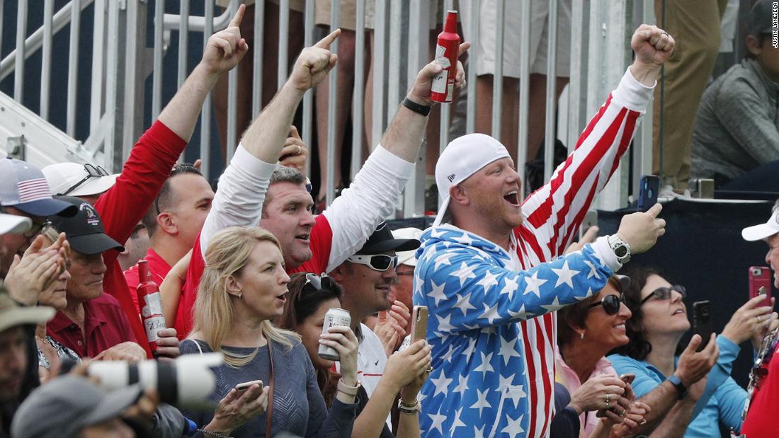 Fans cheer for Tiger Woods on the 13th hole. 