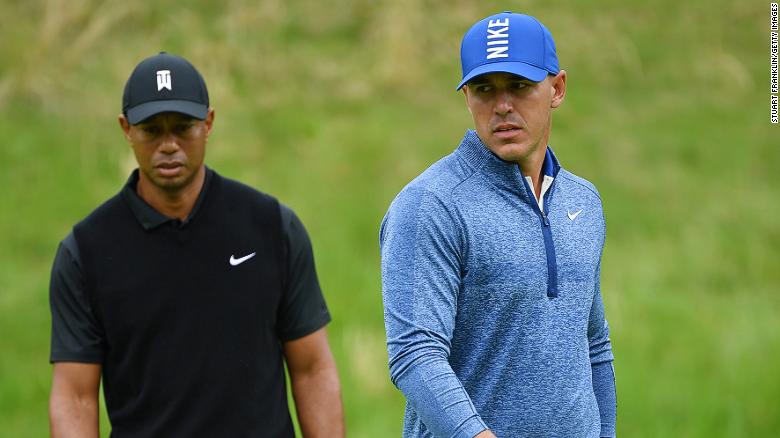 Brooks Koepka (right) stamped his authority on the US PGA as Tiger Woods toiled. 