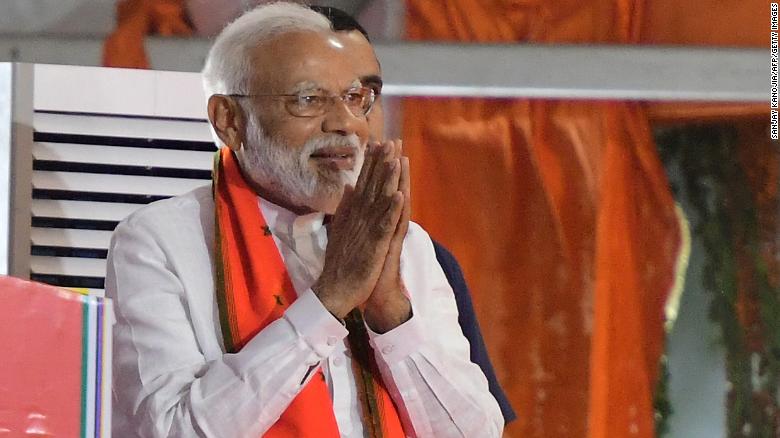 Indian Prime Minister Narendra Modi gestures to supporters as he arrives to a rally ahead of Phase VI of India&#39;s general election in Allahabad on May 9, 2019. (Photo by SANJAY KANOJIA / AFP)        (Photo credit should read SANJAY KANOJIA/AFP/Getty Images)