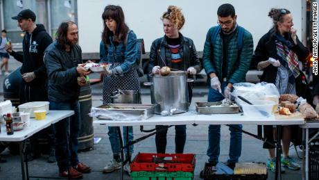  A free hot meal is served by volunteers at a London food bank in 2019.