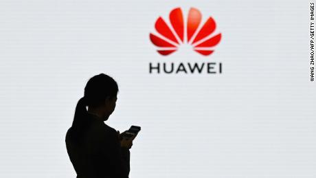 A staff member of Huawei uses her mobile phone at the Huawei Digital Transformation Showcase in Shenzhen, China&#39;s Guangdong province on March 6, 2019. - Chinese telecom giant Huawei insisted on March 6 its products feature no security &quot;backdoors&quot; for the government, as the normally secretive company gave foreign media a peek inside its state-of-the-art facilities. (Photo by WANG ZHAO / AFP)        (Photo credit should read WANG ZHAO/AFP/Getty Images)