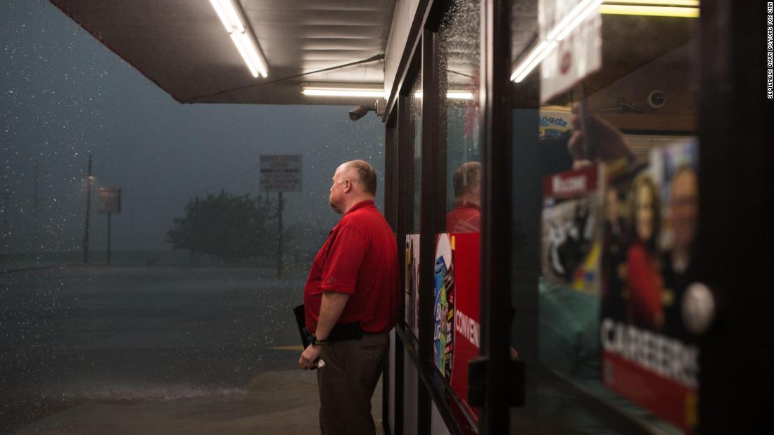 A worker at a gas station checks outside after a storm system passes in Perry, Oklahoma on May 20.