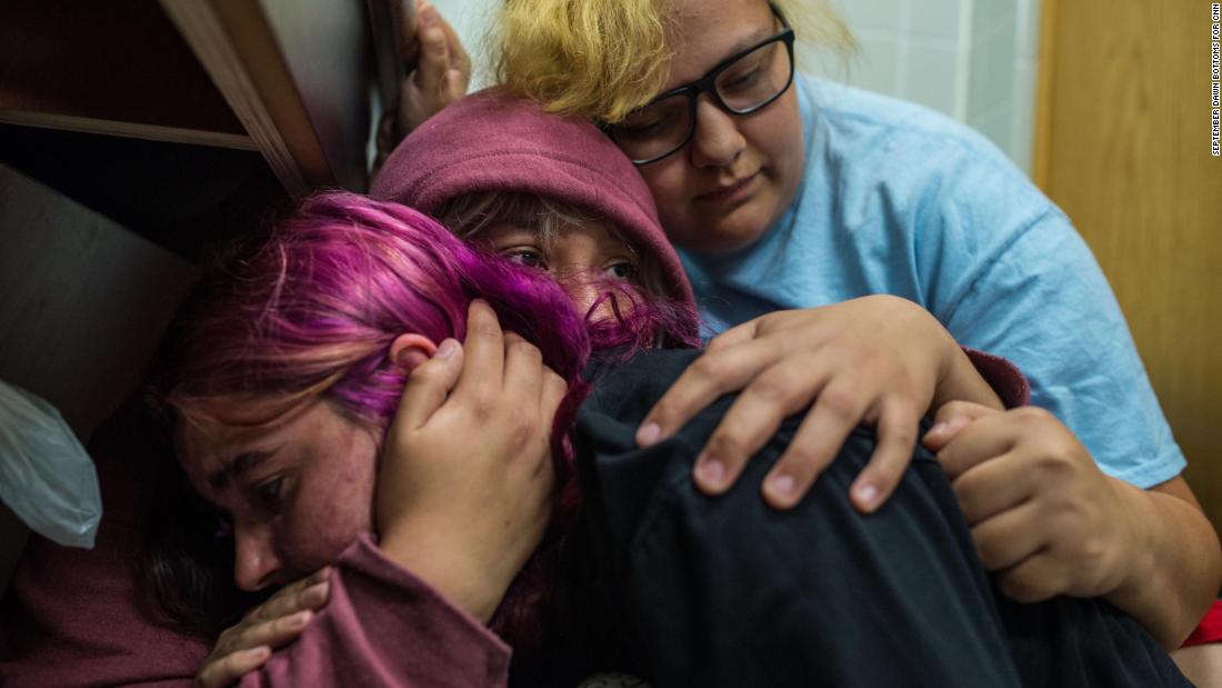 Lila Metcalf, 20; Manuela Martinez, 19; and Skye Perkins, 19, take shelter in a gas station just off I-35 in Perry, Oklahoma on May 20 as a storm passes through.