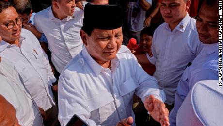 Indonesian Presidential candidate Prabowo Subianto shakes hands with voters after casting his vote at a polling station on April 17, 2019 in Babakan Madang, Indonesia. 