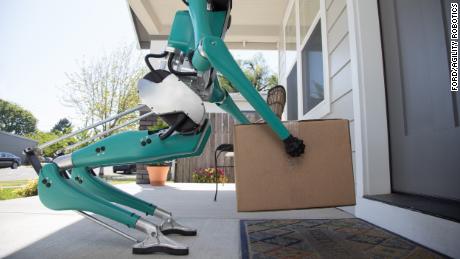 Ford&#39;s robot places a package in front of a door.