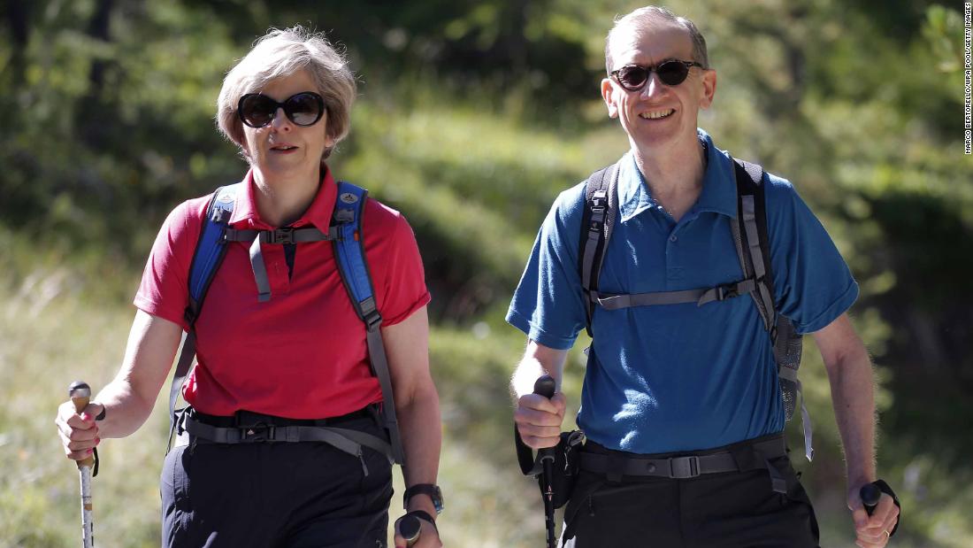 May walks with her husband, Philip, while they vacationed in the Swiss Alps in August 2016.