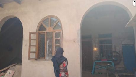 Sahila Khan, the 14-year-old daughter of Rakbar Khan, stands in front of her home in Kolgaon village in Haryana.