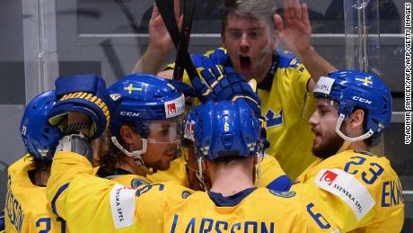 Sweden&#39;s players celebrate next to a fan during a 5-4 victory over Latvia.