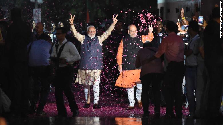 Indian Prime Minister Narendra Modi flashes the victory sign next to president of the ruling Bharatiya Janata Party (BJP) Amit Shah as they celebrate their victory in India&#39;s general elections.