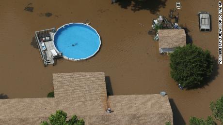 An aerial image shows the extent of flooding in Sand Springs, west of Tulsa.