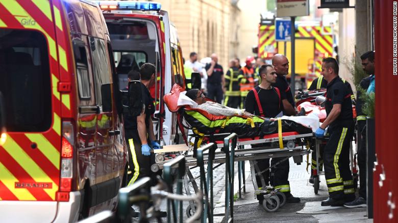 Emergency workers wheel a woman on a stretcher to a waiting ambulance in Lyon on Friday. 