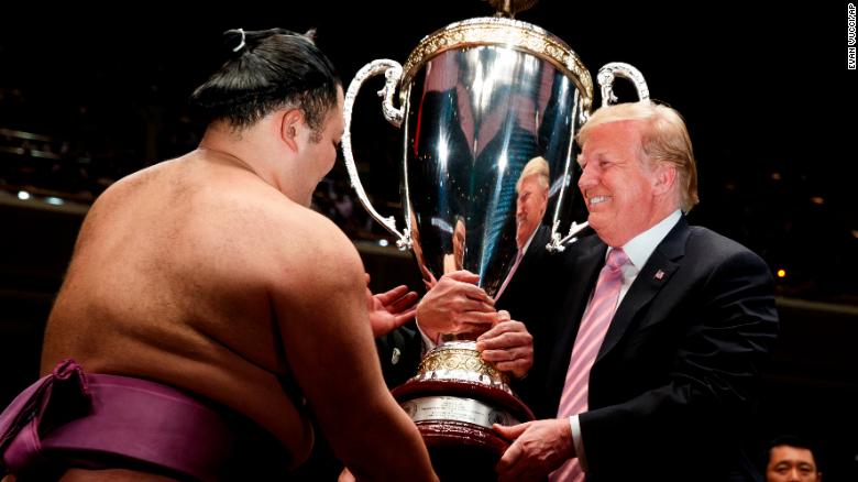 Donald Trump presents the President&#39;s Cup to the Tokyo Grand Sumo Tournament winner Asanoyama, at Ryogoku Kokugikan Stadium. 