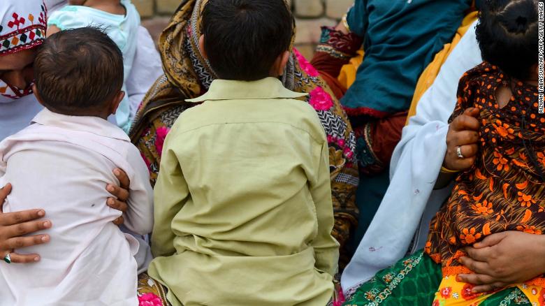 Pakistani women hold their HIV infected children as they gather at a house at Wasayo village in Rato Dero in the district of Larkana of the southern Sindh province on May 8, 2019. 