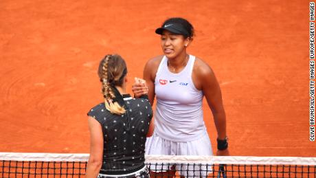 Naomi Osaka (in cap) and Victoria Azarenka shake hands after their match at the French Open. 