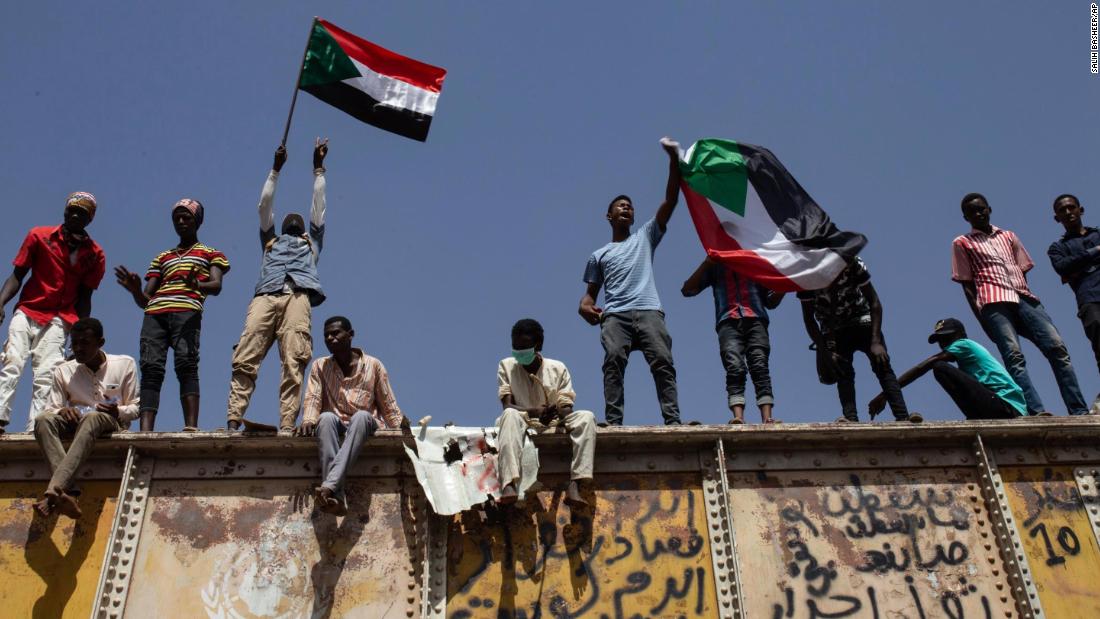 Protesters wave national flags at a sit-in outside the military headquarters in Khartoum on May 2.