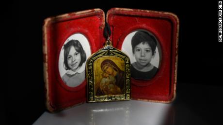 Childhood photographs of siblings Carla and Carlos Jr. Their mother carries these photographs and a necklace of the Virgin Mary everywhere she goes. 