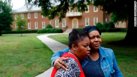 Shelia Cook, left, and Renee Russell, members of Mount Olive Baptist Church, embrace after praying near a municipal building that was the scene of a shooting, Saturday, June 1, 2019, in Virginia Beach, Va. A longtime city employee opened fire at the building Friday before police shot and killed him, authorities said. (AP Photo/Patrick Semansky)