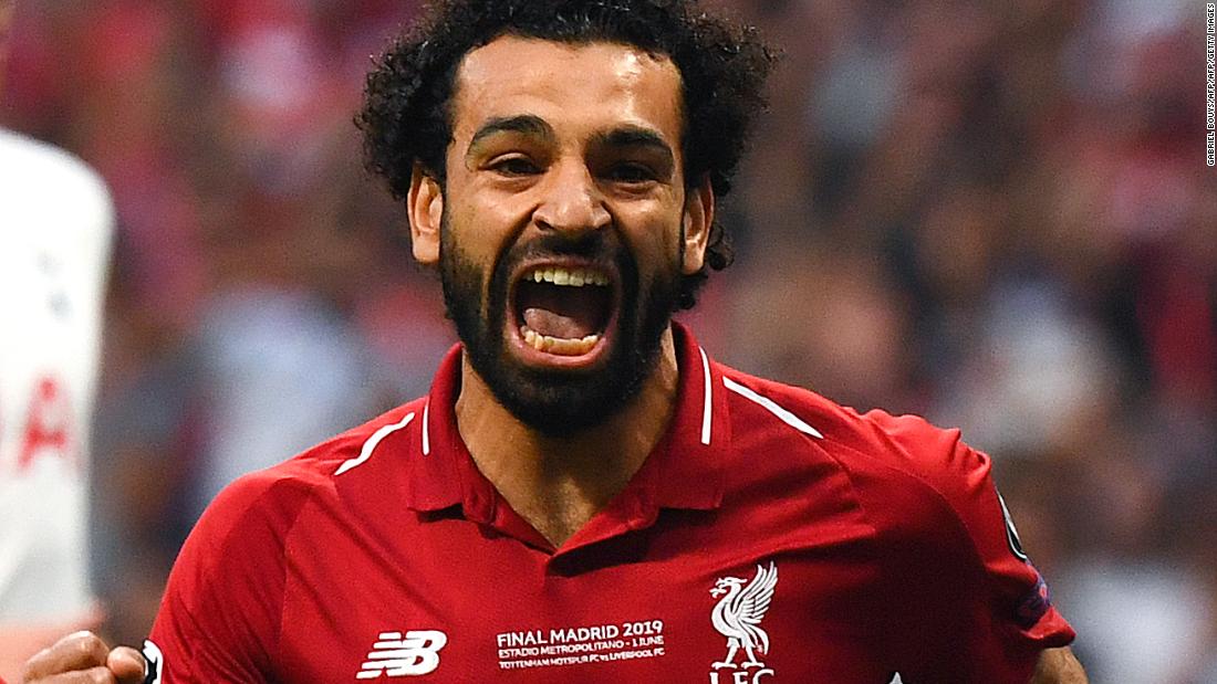 Liverpool&#39;s Egyptian forward Mohamed Salah celebrates after scoring the opening goal on a penalty in the second minute of the match. 