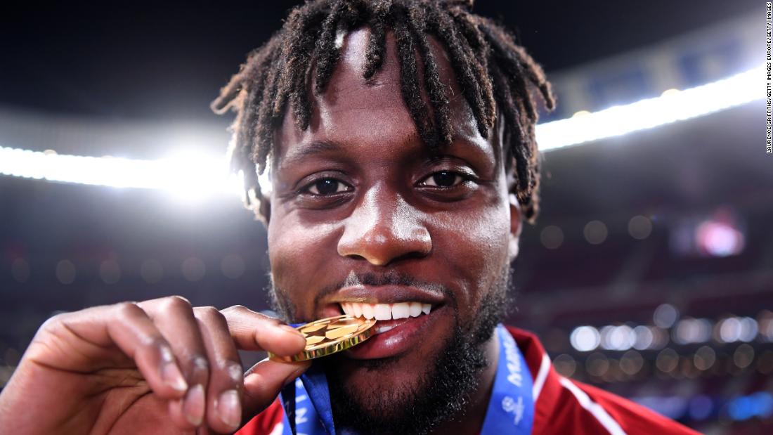 Divock Origi of Liverpool -- who came on to score the second goal -- celebrates with his medal after the match. 
