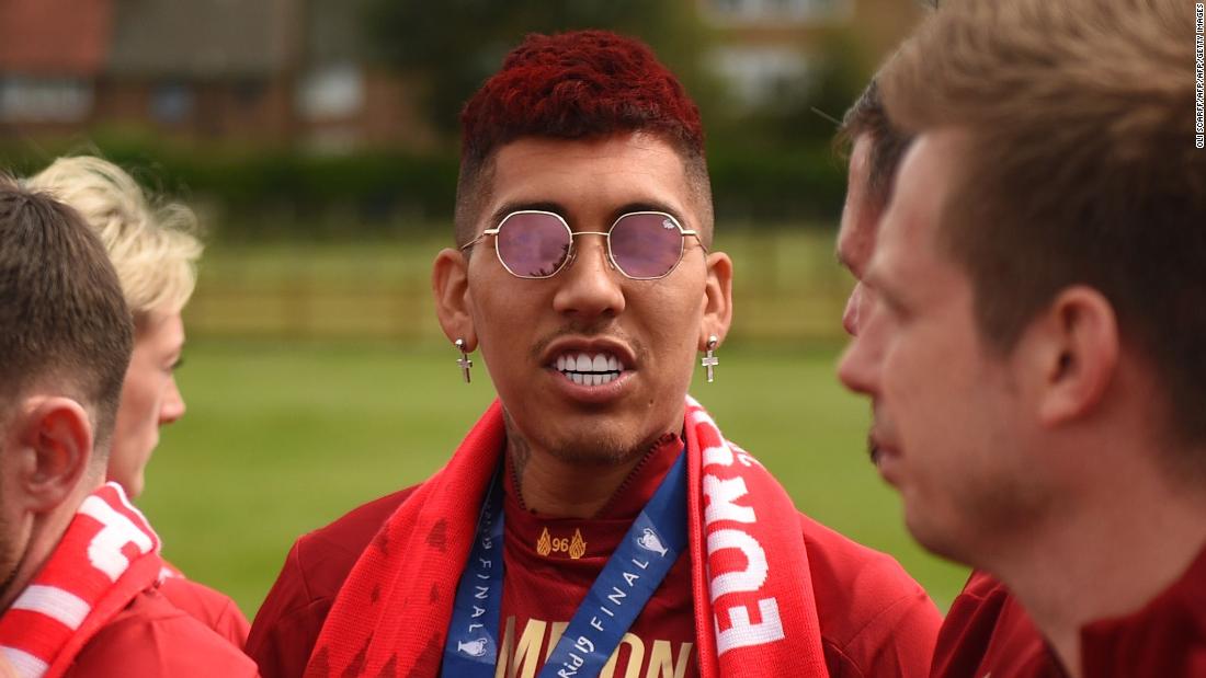 Liverpool&#39;s Brazilian midfielder Roberto Firmino shows off his celebratory red hairstyle &lt;br /&gt;during an open-top bus parade around the city on Sunday. 