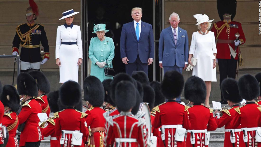The US National Anthem is played during a welcoming ceremony at Buckingham Palace. From left are Melania Trump, the Queen, Trump, Charles and Camilla.