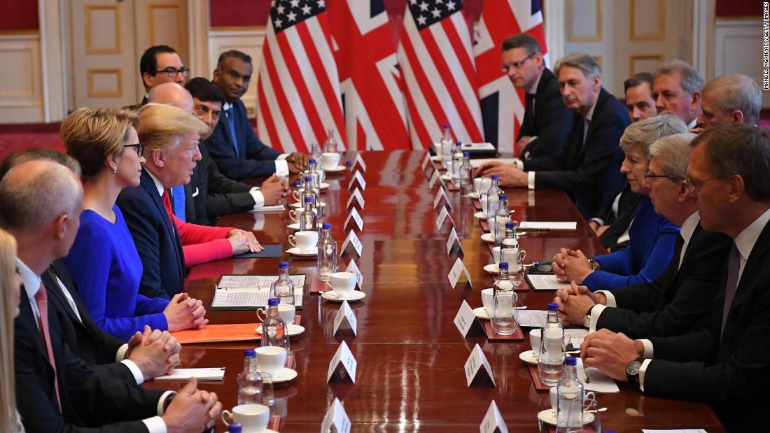 Trump speaks opposite May at a business roundtable discussion in London.