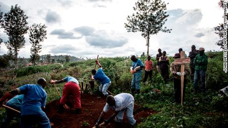 Family members watch the deceased victim of the Ebola virus being buried on May 16, 2019 in Butembo. The city of Butembo is at the epicentre of the Ebola crisis in the DR Congo. 