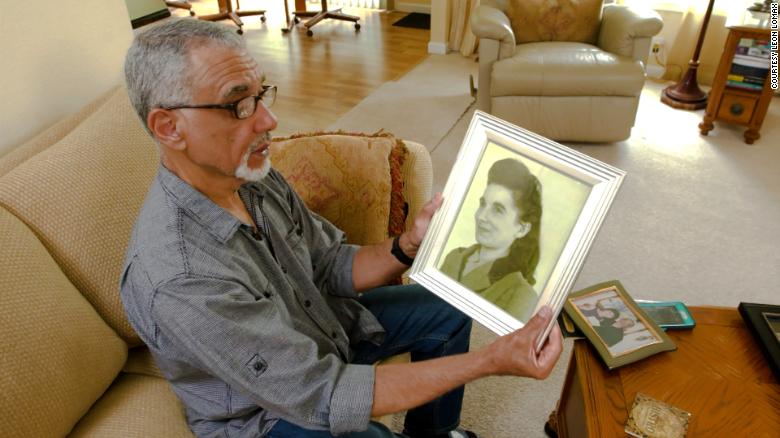 Leon Lomax with a photograph of his mother. He is haunted by the question of why she gave him up.