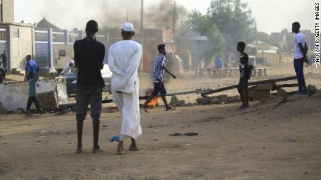 Locals block a street to stop military vehicles entering their neighborhood in Khartoum on June 4.