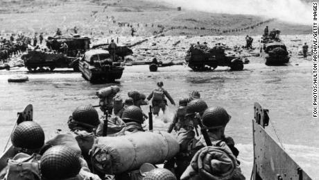 US assault troops and equipment landing on Omaha beach the day following D-Day