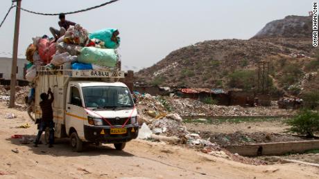 Lokesh collects plastic waste from the landfill to recycle into plastic sacks or slippers. 