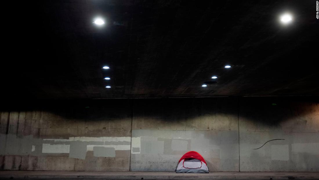 A homeless person&#39;s tent is pitched on a sidewalk underneath Interstate 110 on January 3.