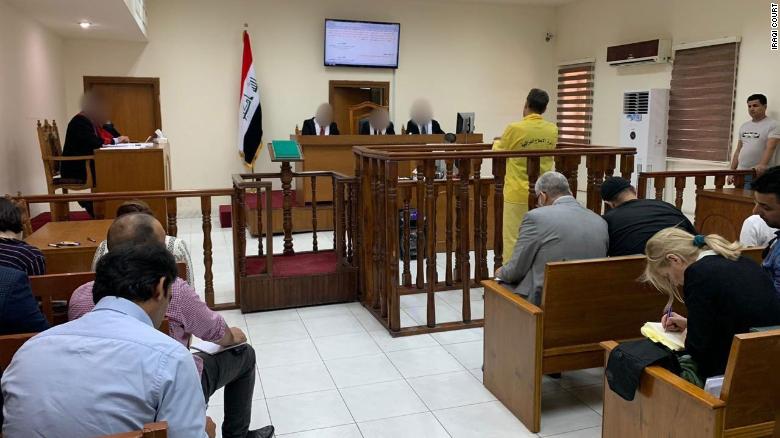 Murad Mohammad Mustafa stands with his back to the camera at the Iraqi court in in Baghdad on Monday, June 3.