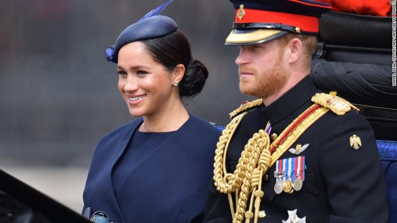 Meghan and Prince Harry make their way in a horse-drawn carriage to Horseguard's Parade ahead of Trooping the Colour.