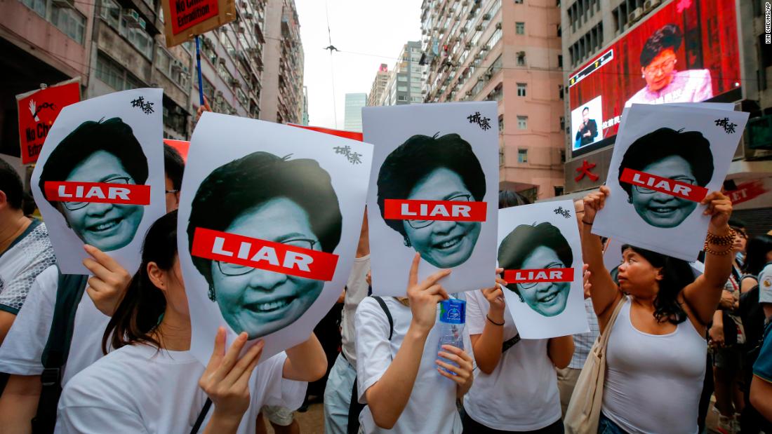 Protesters hold pictures of Hong Kong Chief Executive Carrie Lam on Sunday, June 9.